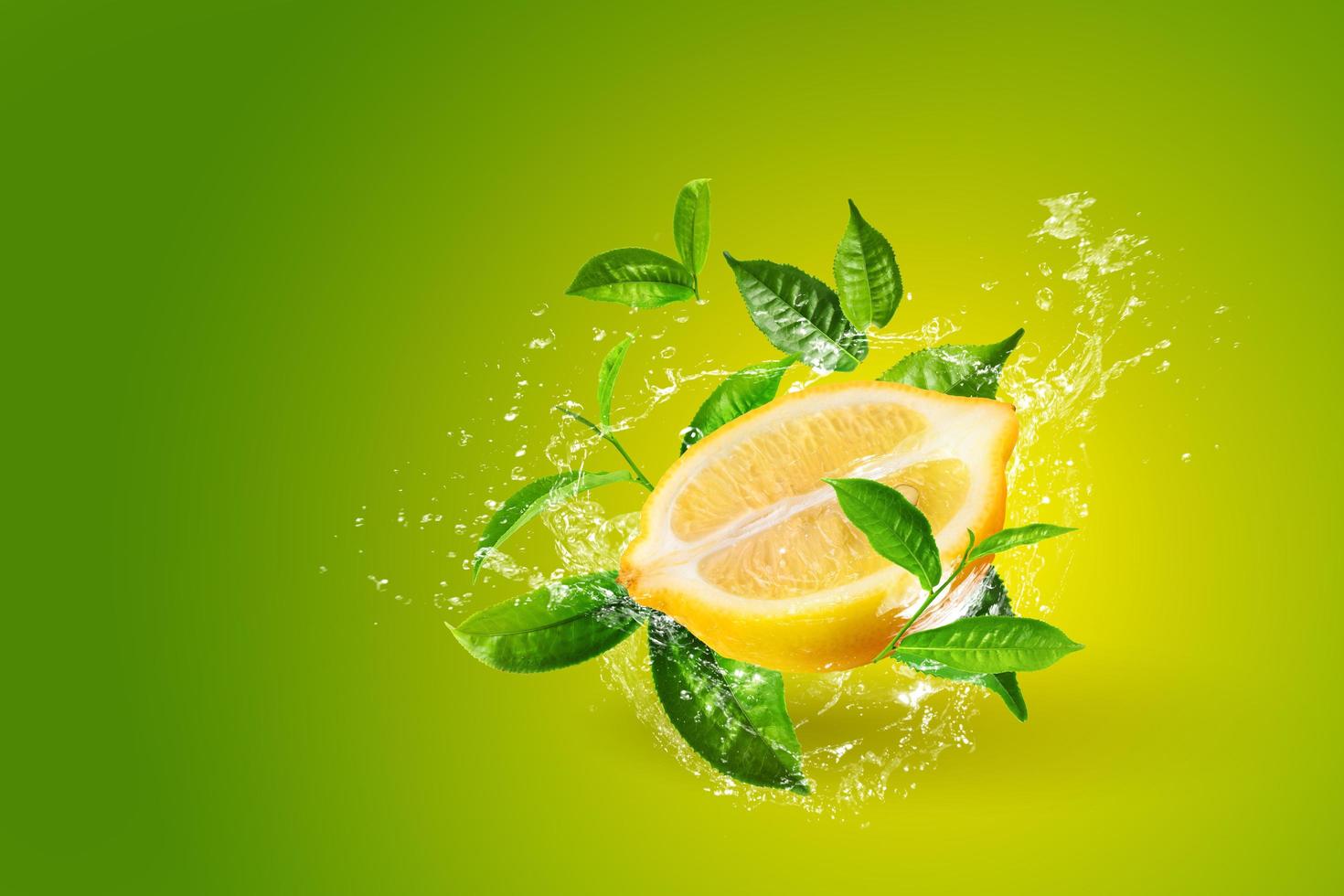 Water splashing on lemons and green tea leaf  photo