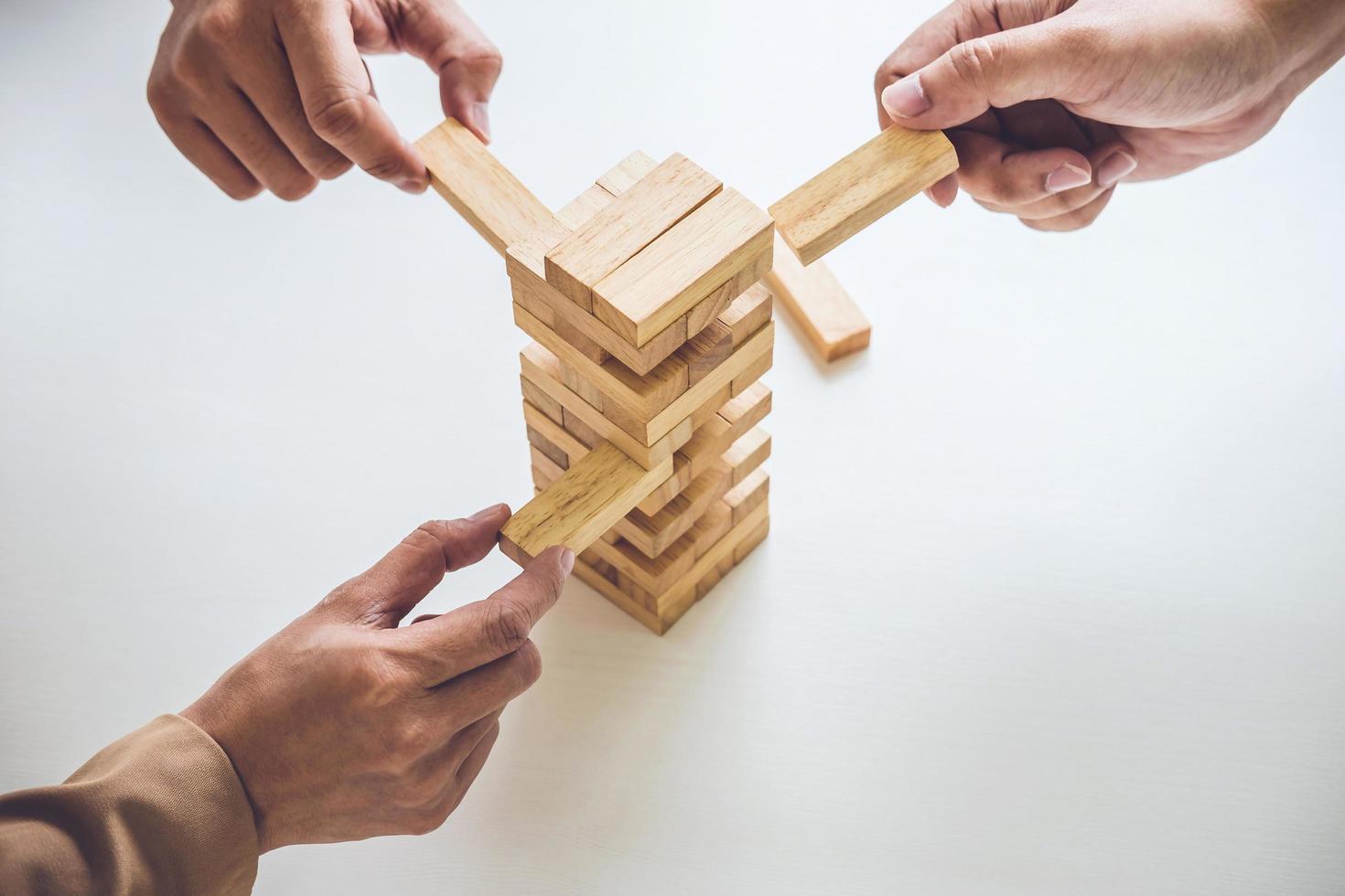  Young business team placing wood block on tower photo