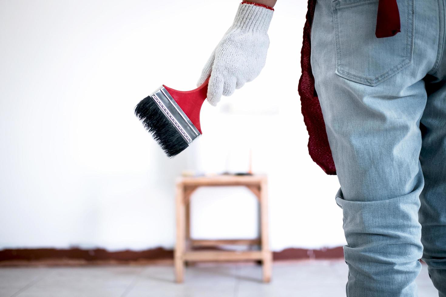 Painter in white glove painting wall  photo