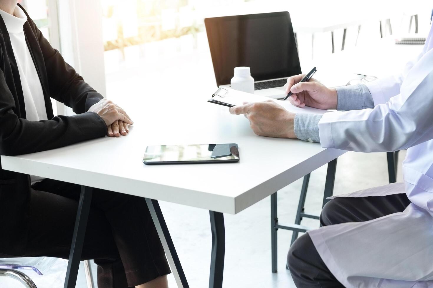 Female doctor and patient discuss paperwork together in a consultation photo