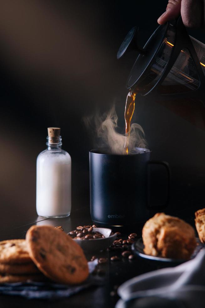 Coffee being poured in breakfast setting photo