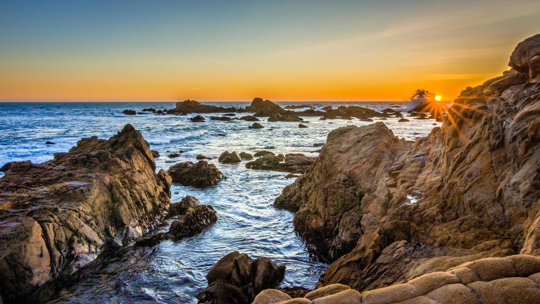 Rocky beach at sunset photo