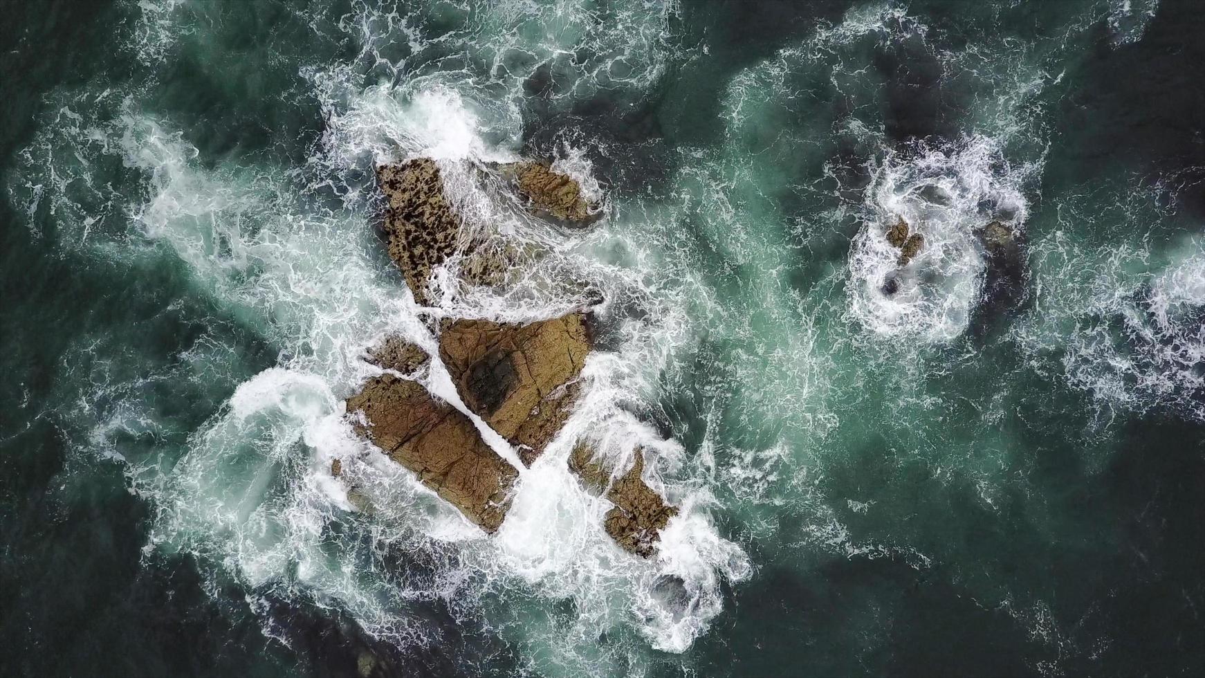 Waves splashing on rocks photo