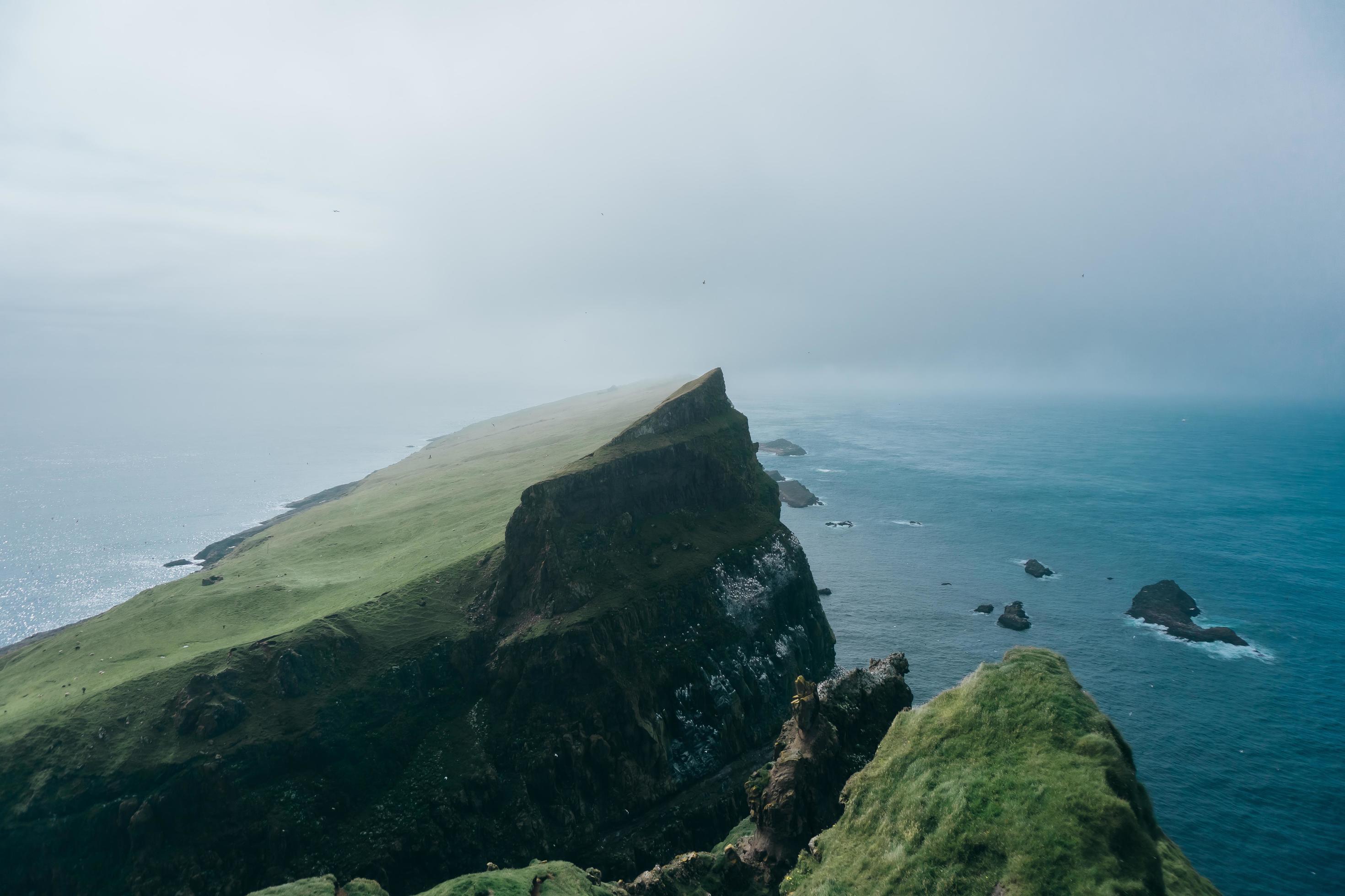 Cliff near ocean under foggy sky 1241909 Stock Photo at Vecteezy