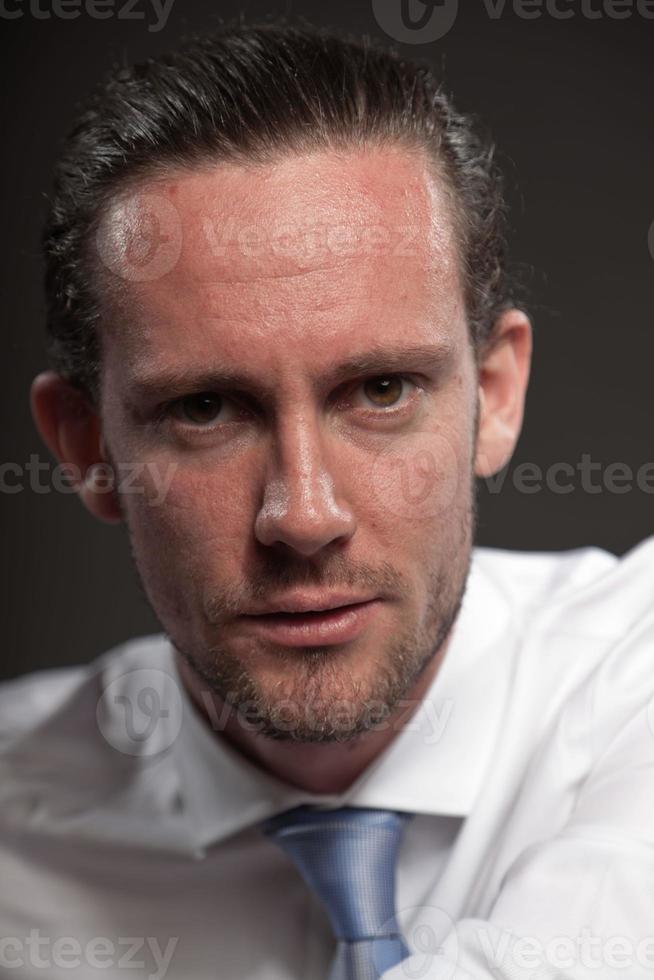 Man brown hair wearing shirt and tie showing emotions. photo