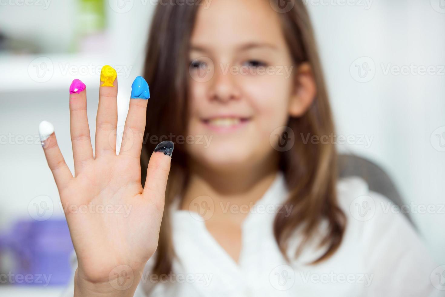 Beautiful schoolgirl playing with colors photo