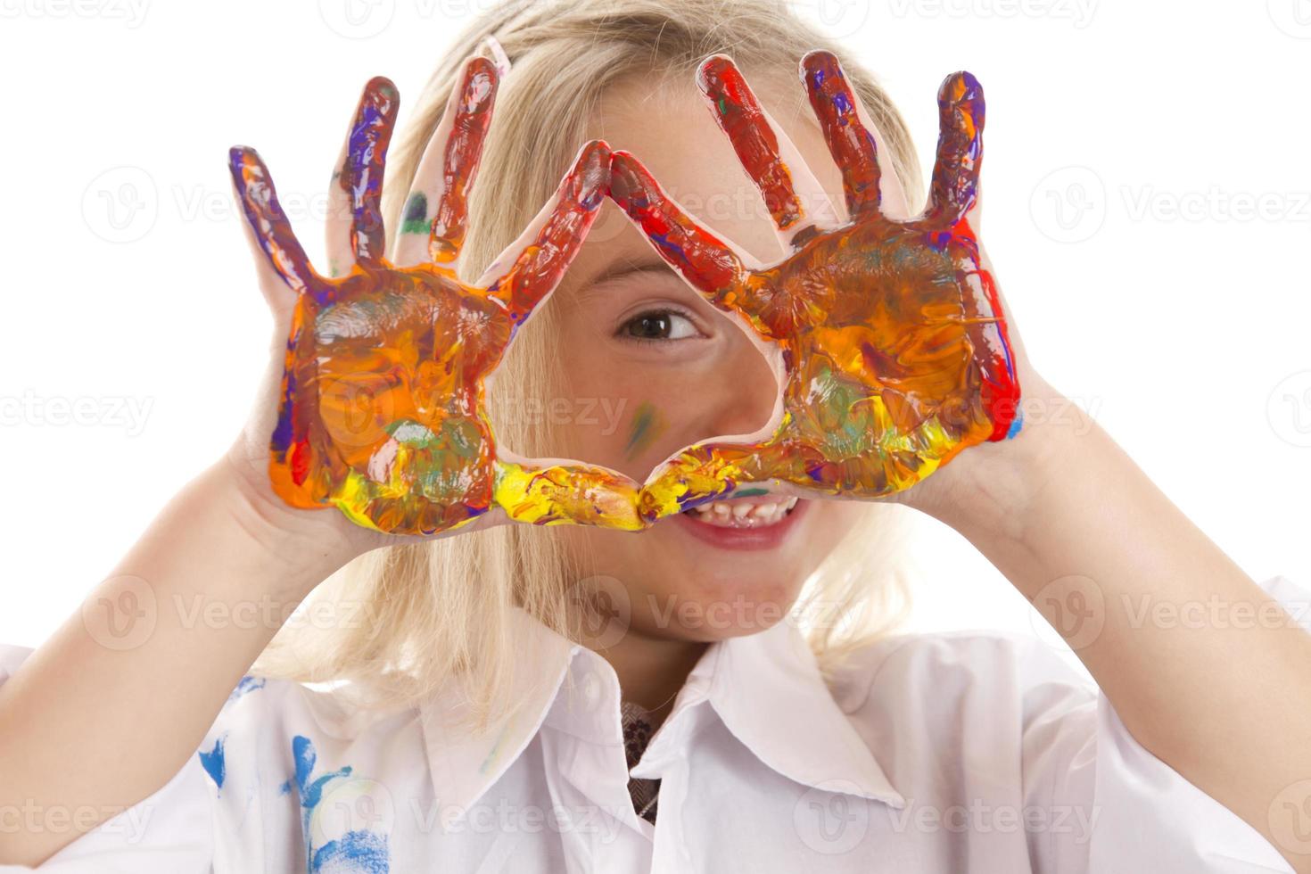 Little girl with her painted hands up photo