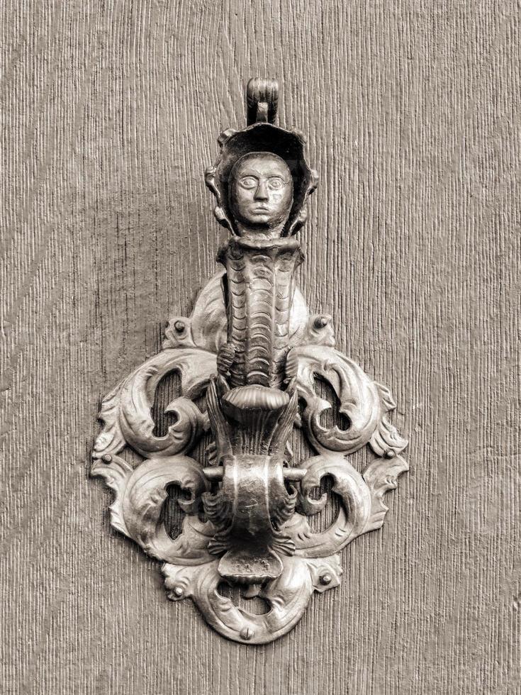 Vintage doorknob on antique door, background photo