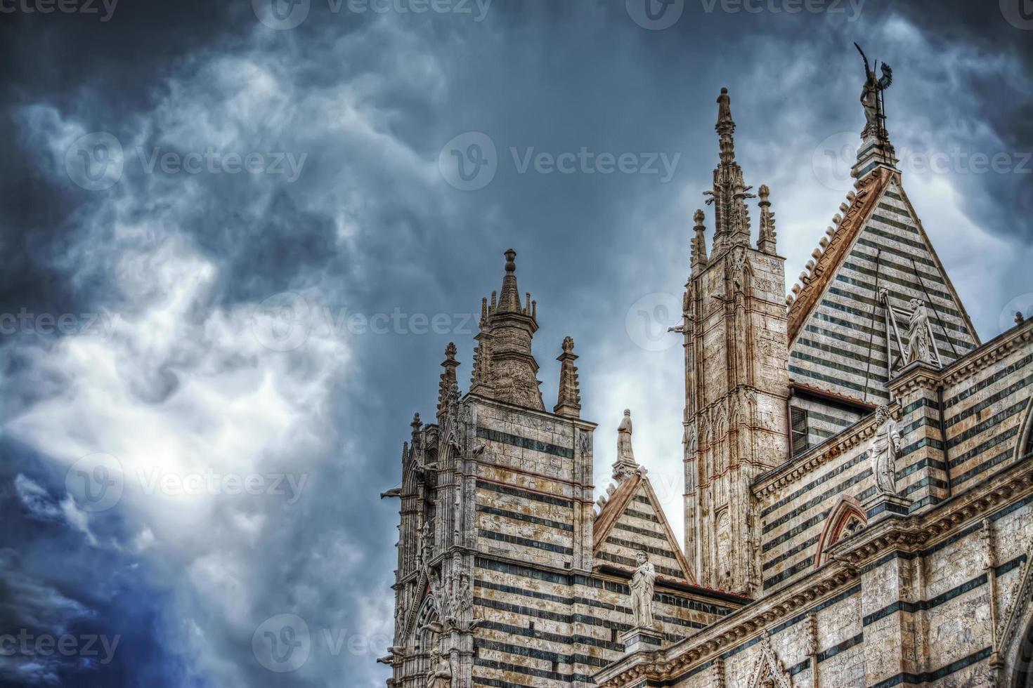 Siena Duomo under a dramatic sky seen from behind photo