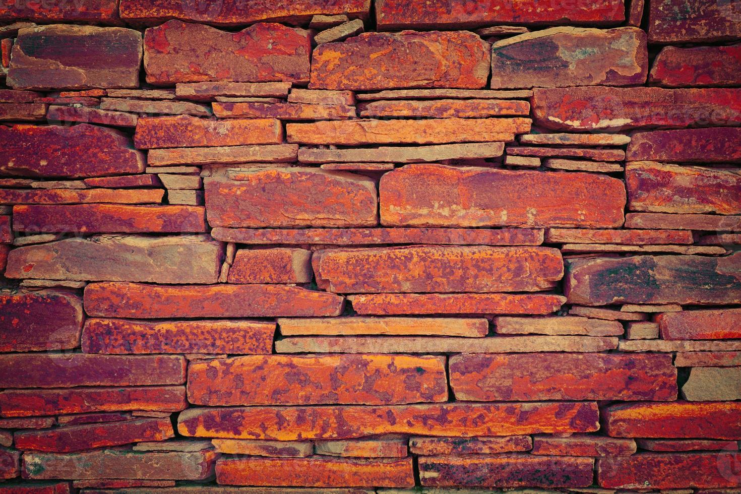 Grunge vintage wall of stone tiles photo