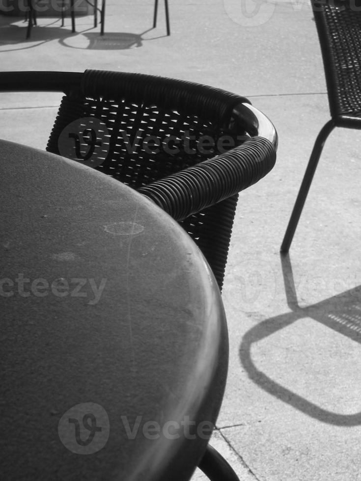 Black and White Cafe Chairs and Metal Table photo