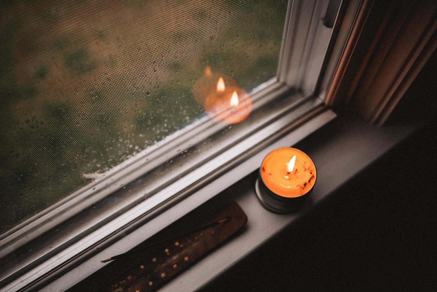 Candle on windowsill photo