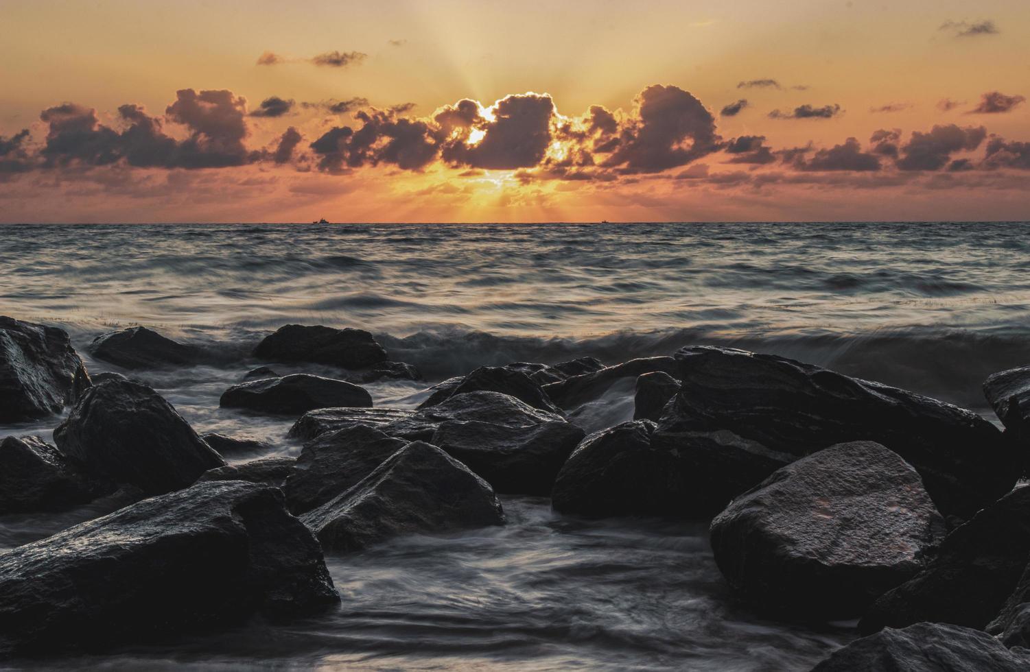 Rocky beach at sunset photo