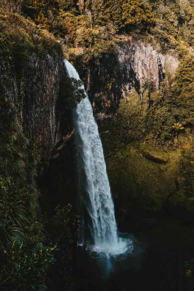 Waterfall, rocks, and trees photo