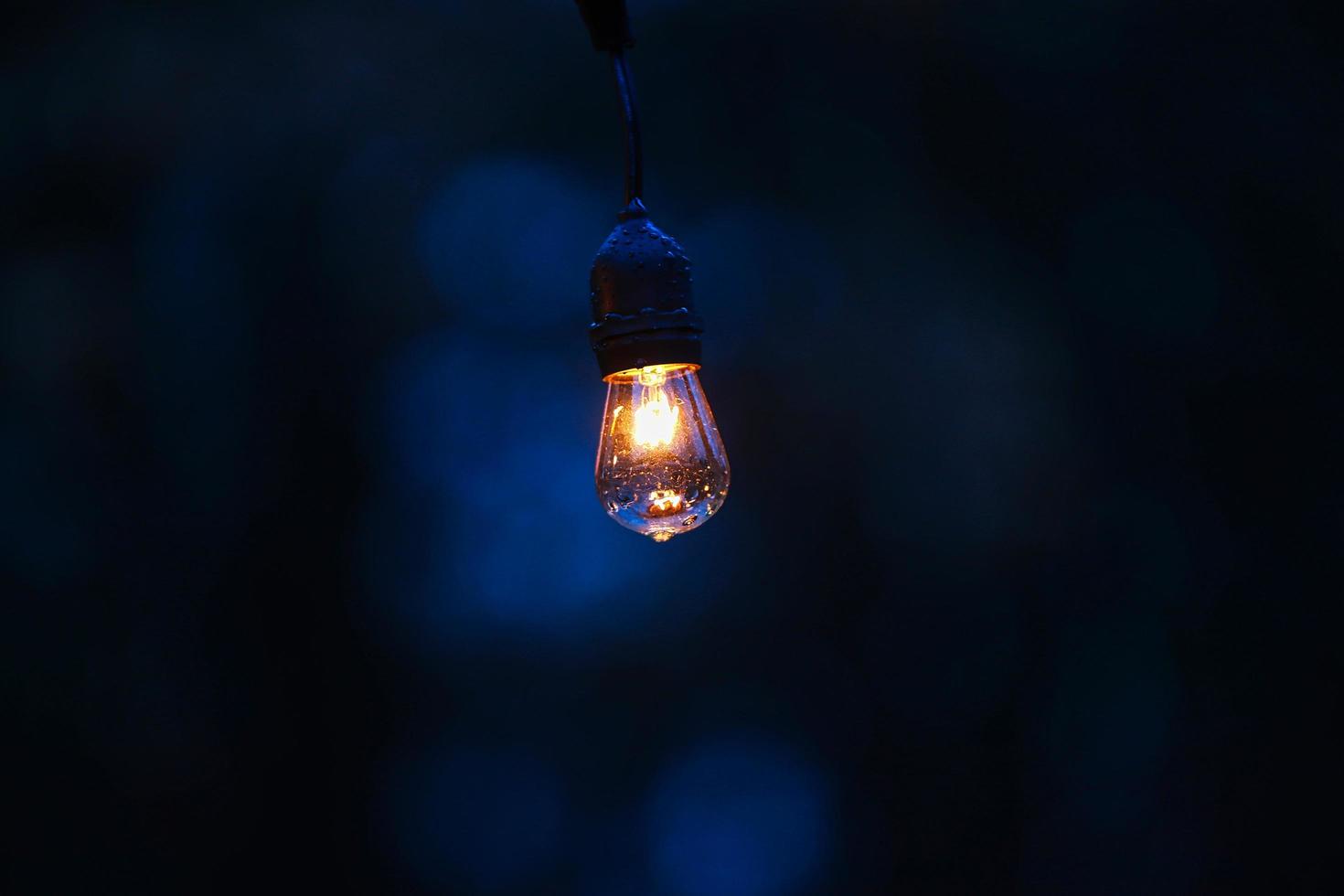 Vintage light bulb in dark room photo