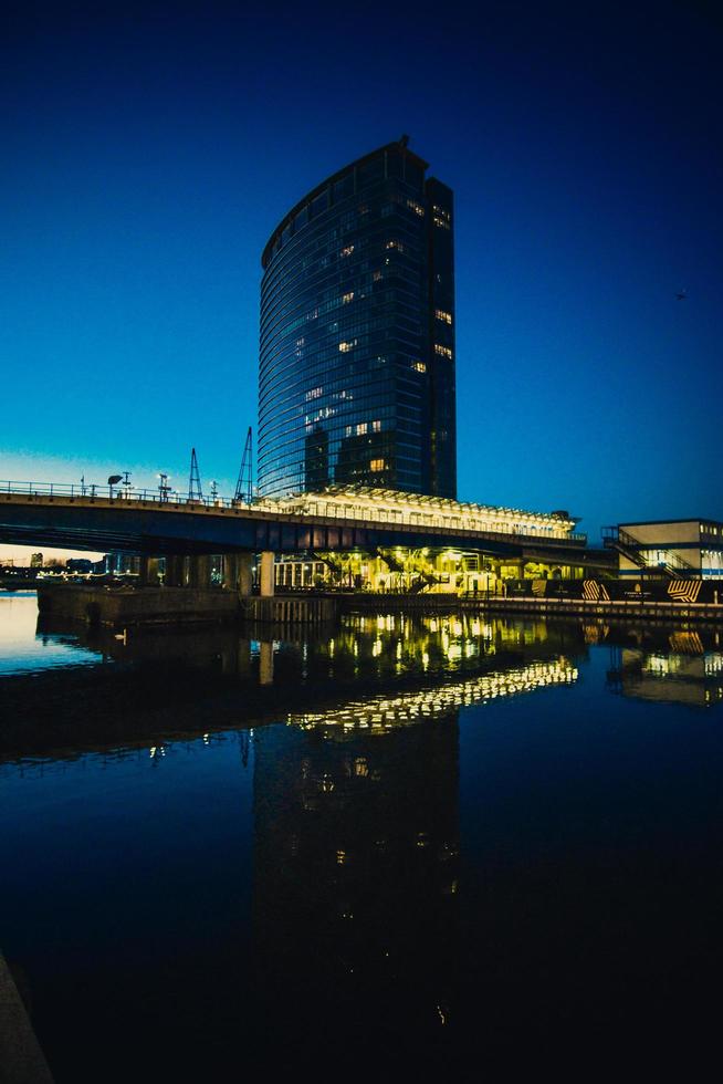 edificio de oficinas de gran altura junto al agua foto