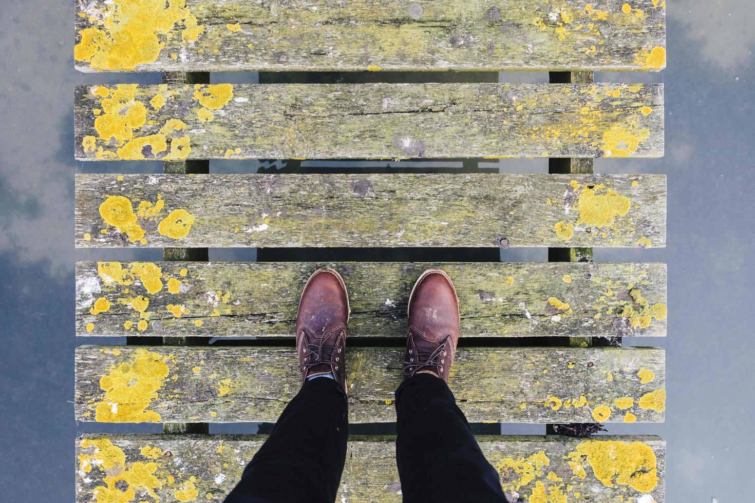 Brown leather shoes on grey and yellow bridge photo