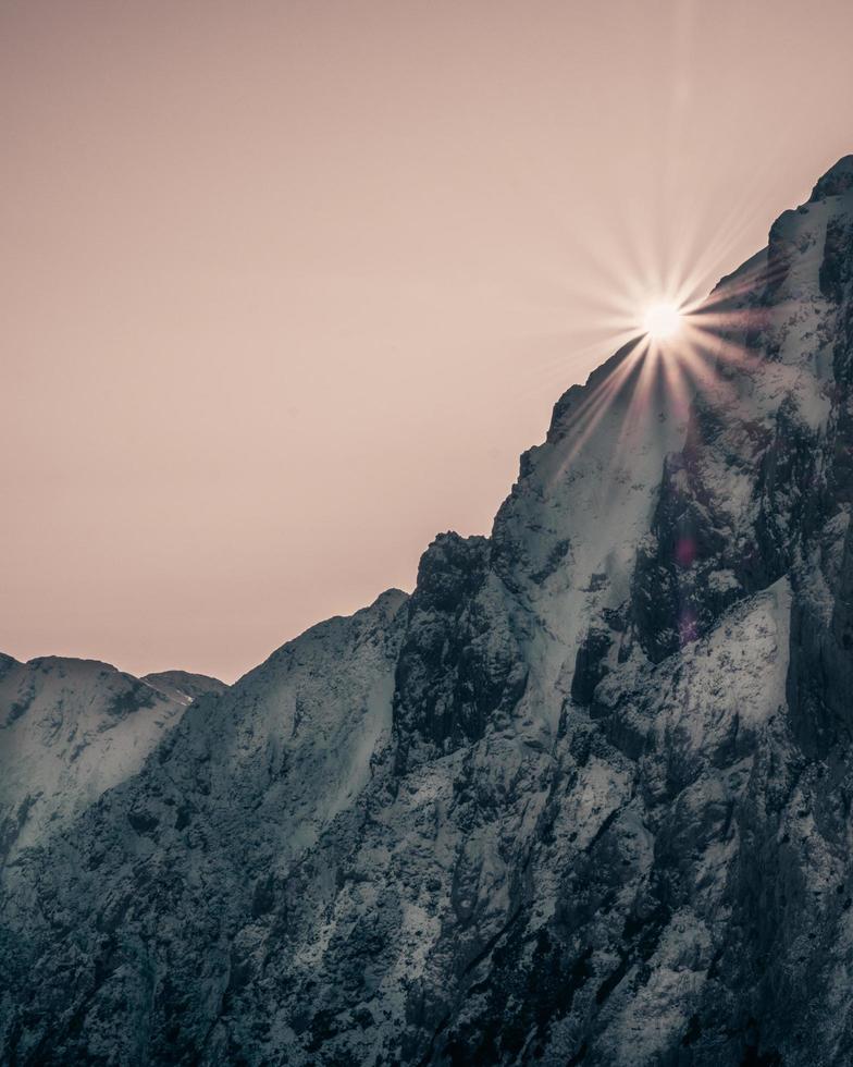 Gray rocky mountain under pink sky photo