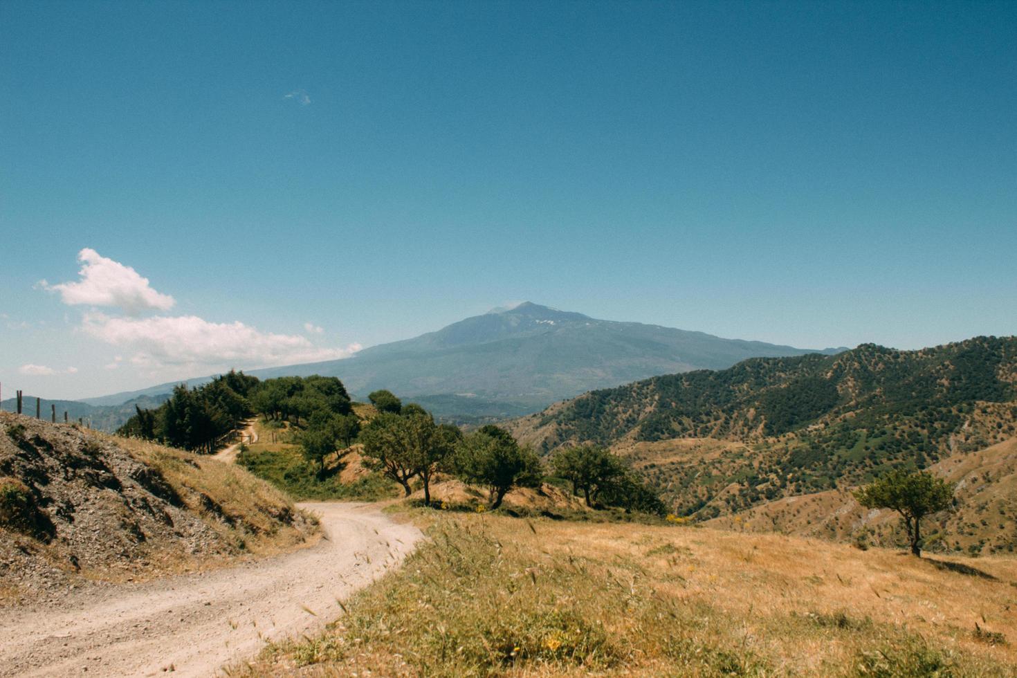 Dirt road through mountains photo