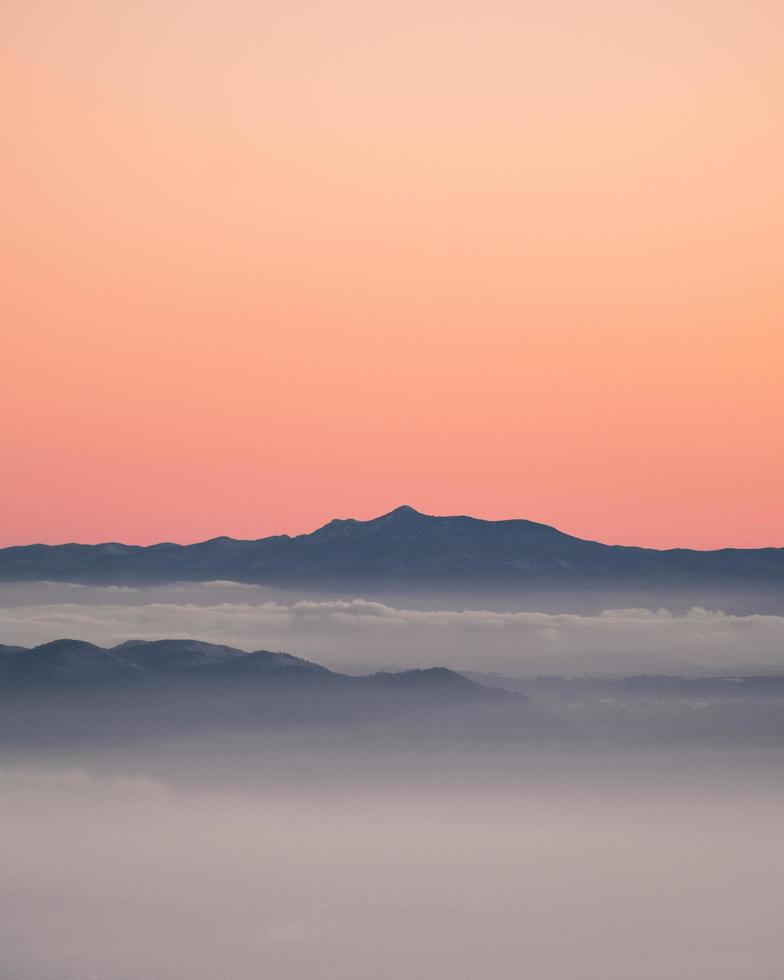 Gray mountain under sunset sky photo