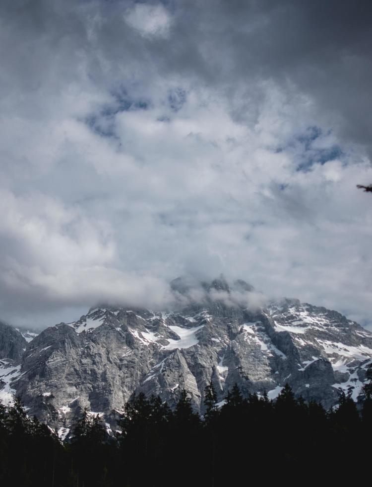 Snowcapped mountain under white clouds photo