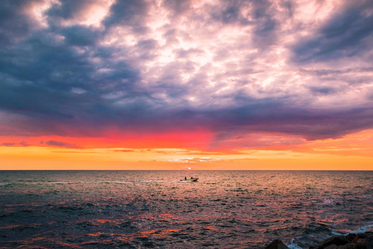 Boat on sea at sunset photo