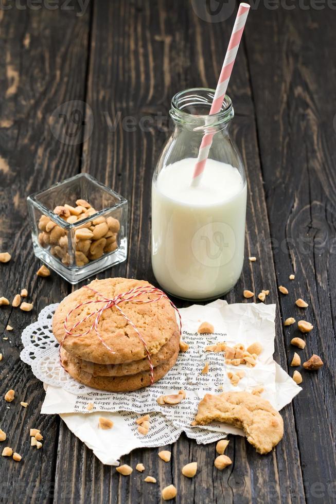 Peanut butter cookies, milk and peanuts on a wood surface 1249774 Stock
