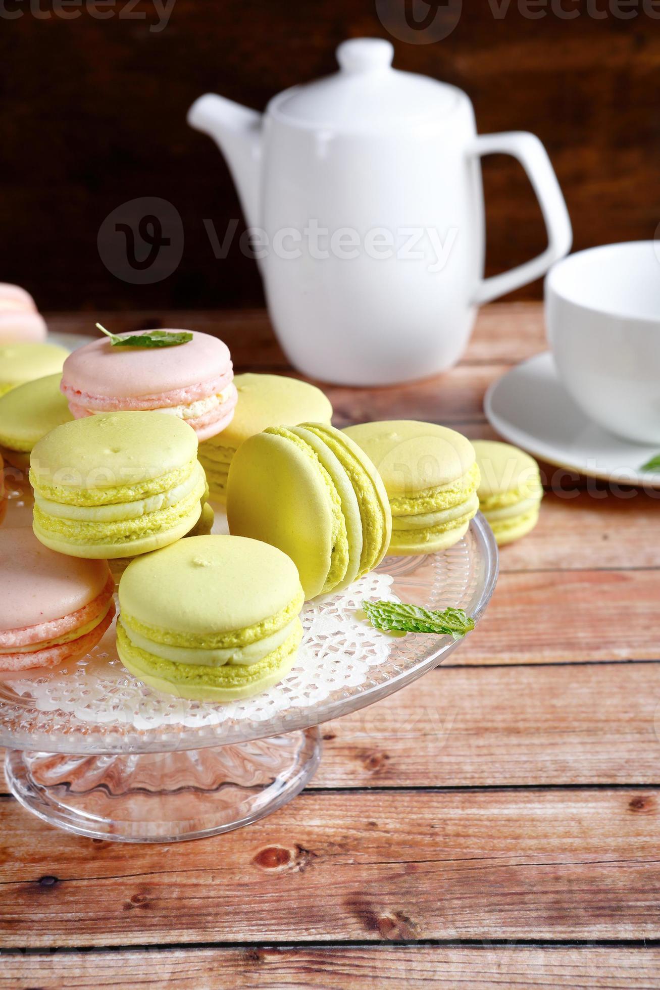 Macaroon on a stand with teapot and cup photo