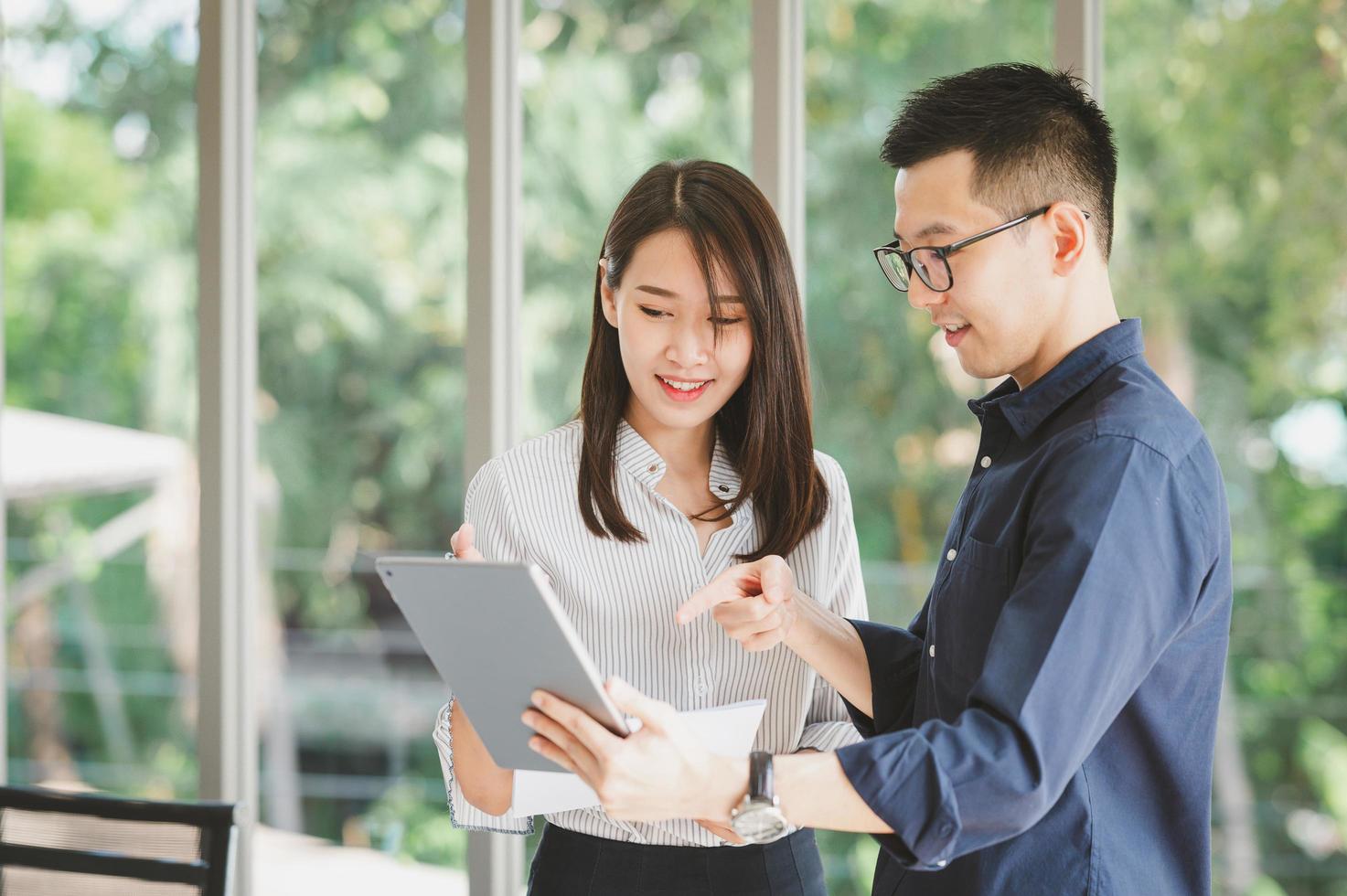 Asian businessman and woman discussing new business project photo