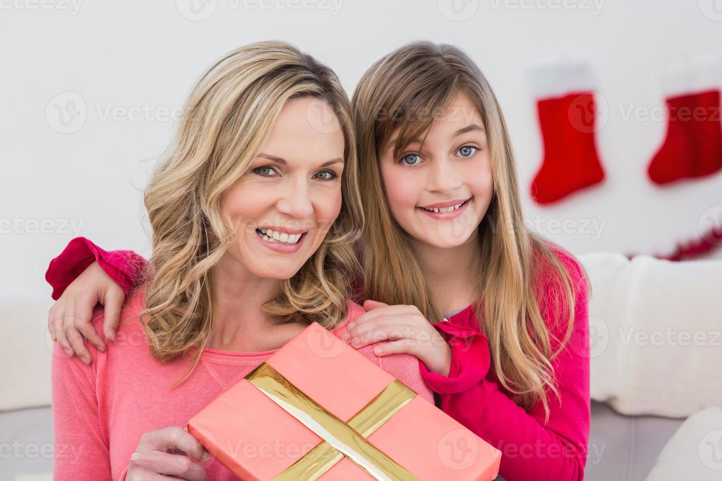Festive mother and daughter smiling at camera photo