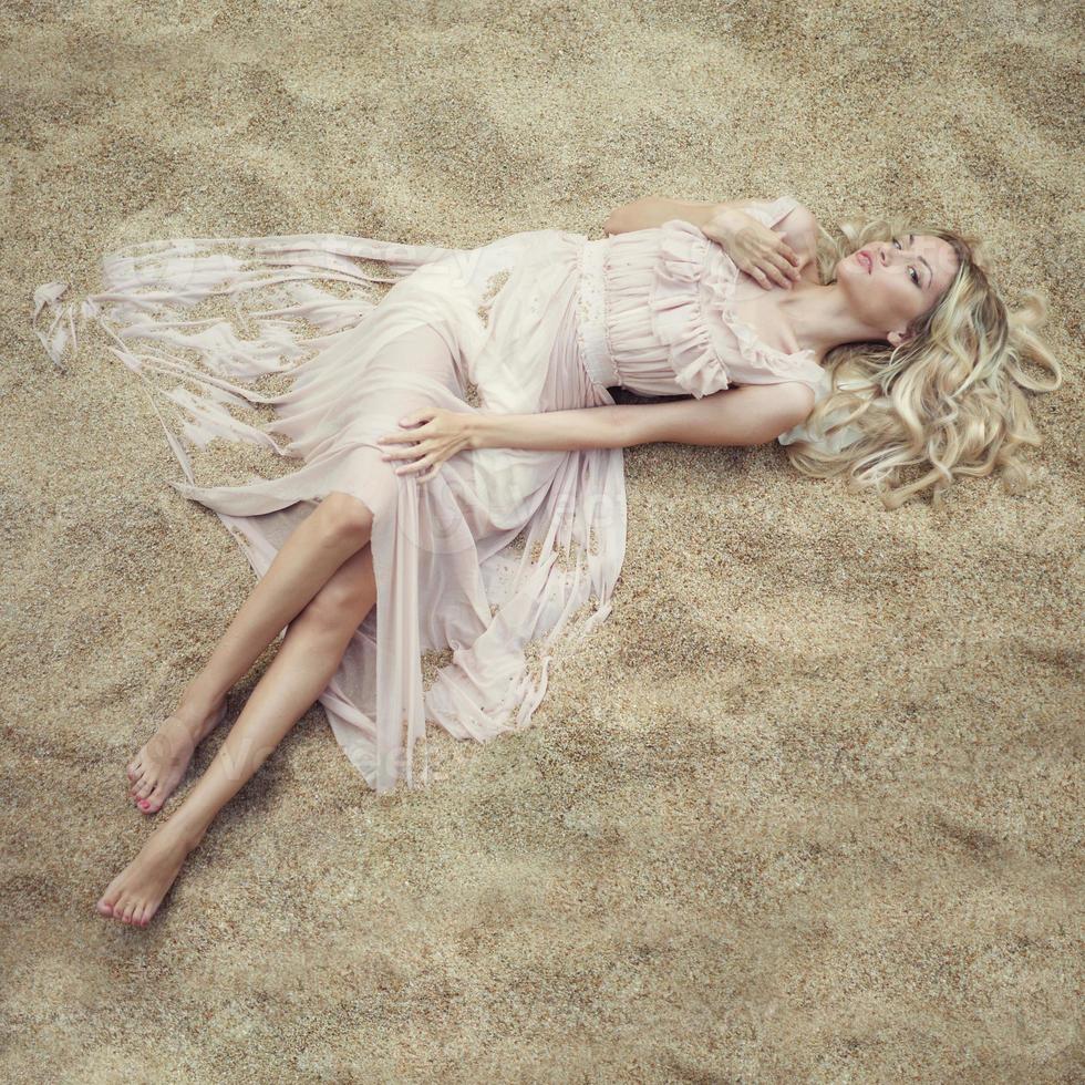 Beautiful woman on sand photo