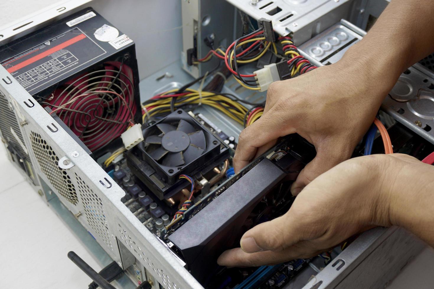 Technician replacing a graphics card photo