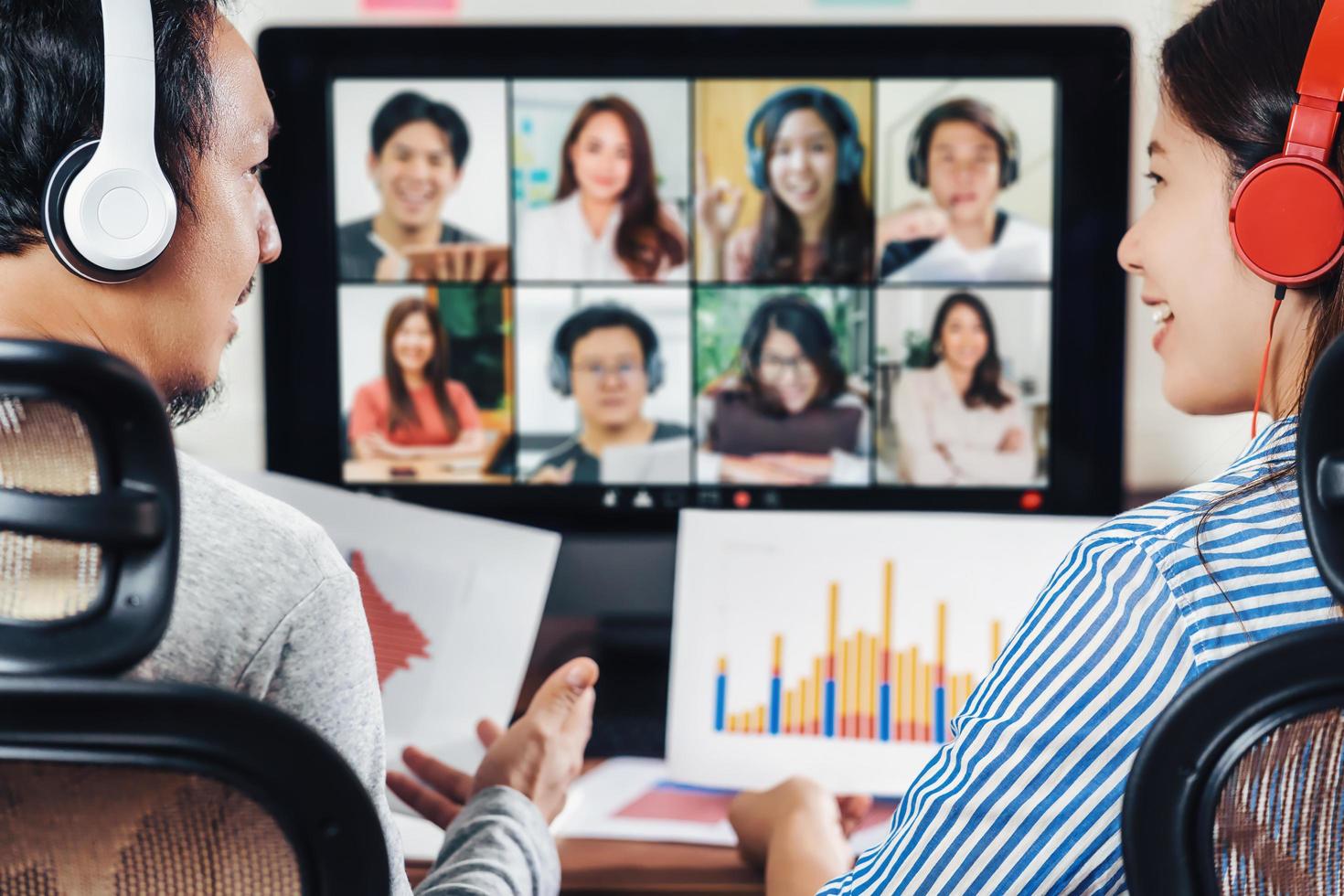 Rear view of Asian partners working on online meeting  photo