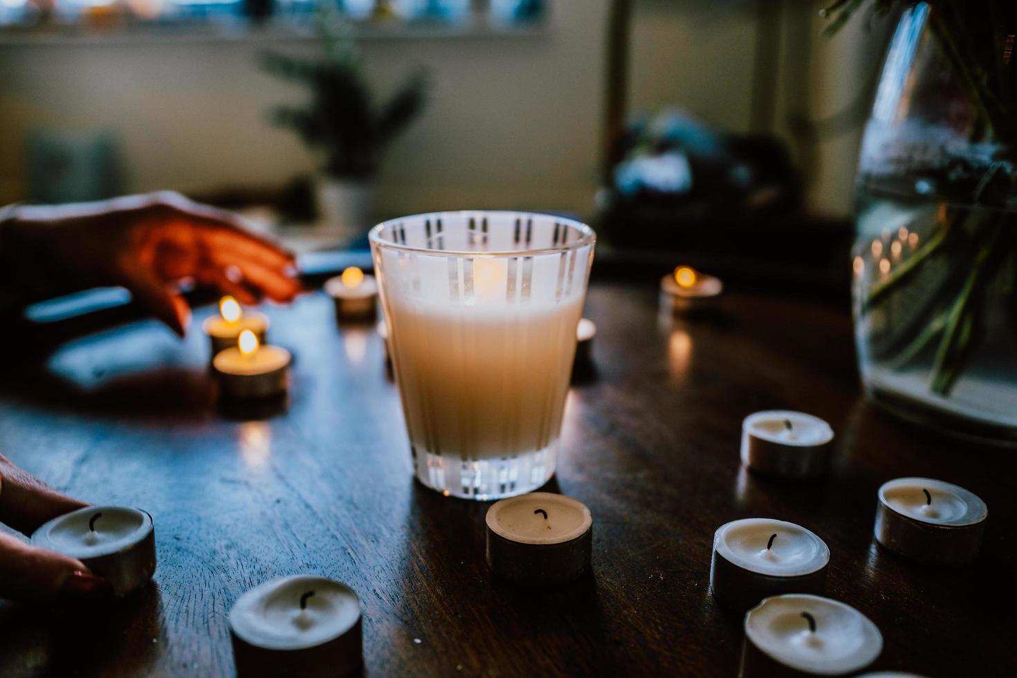 Close-up of people lighting candles photo