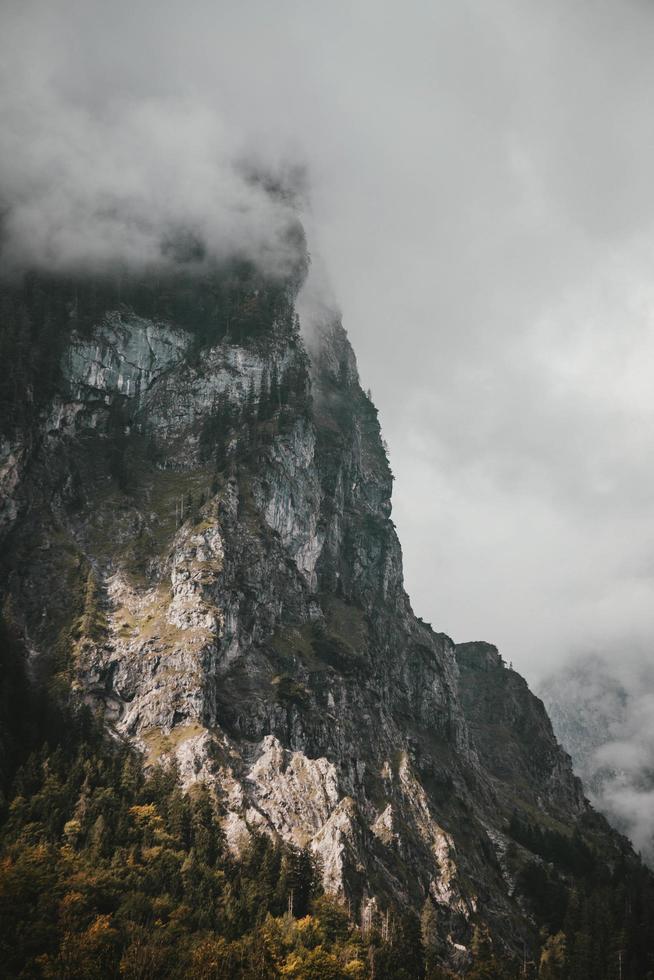 Gray mountain surrounded by clouds photo