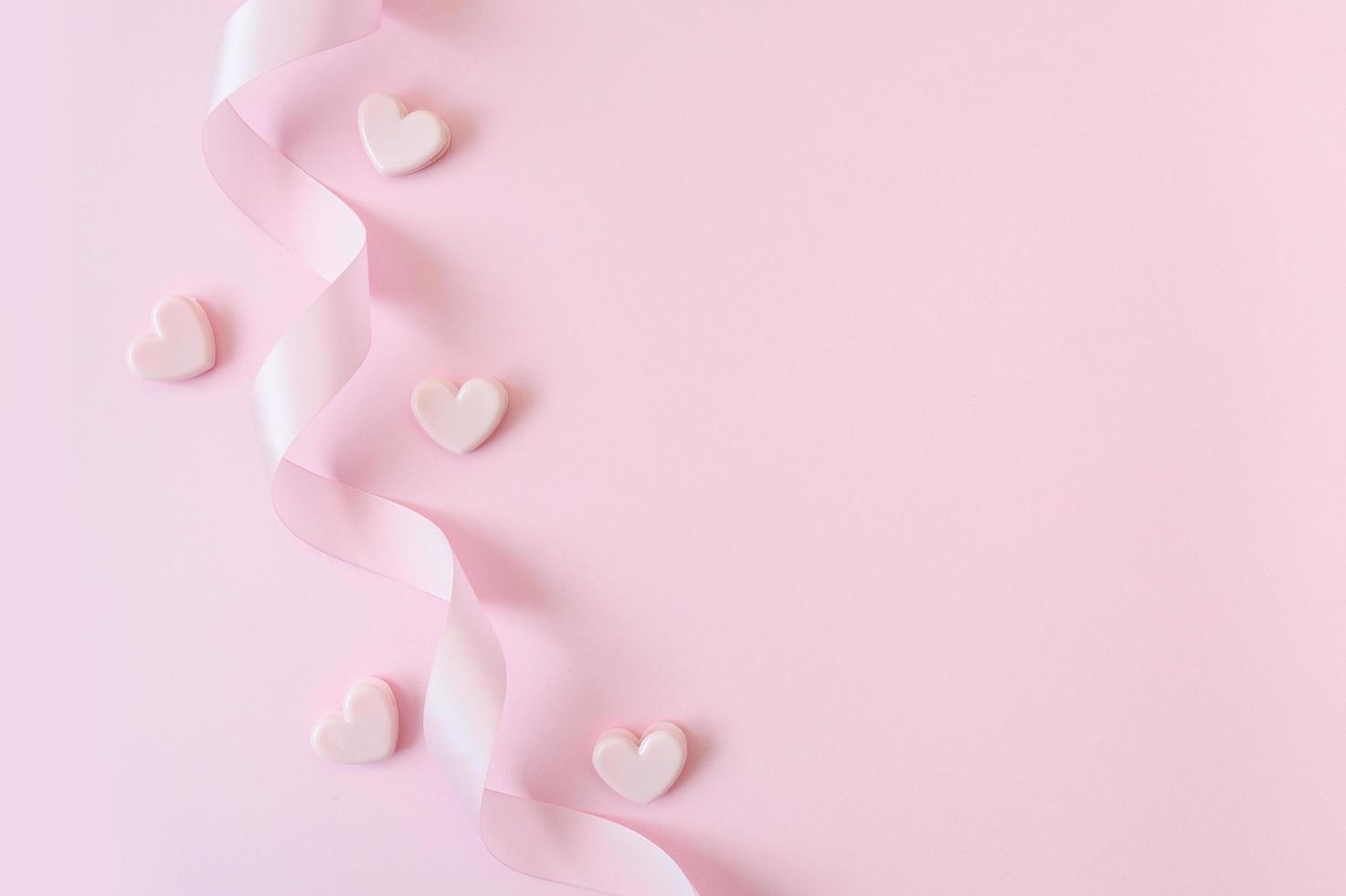 Pink ribbon and hearts on a pink background  photo