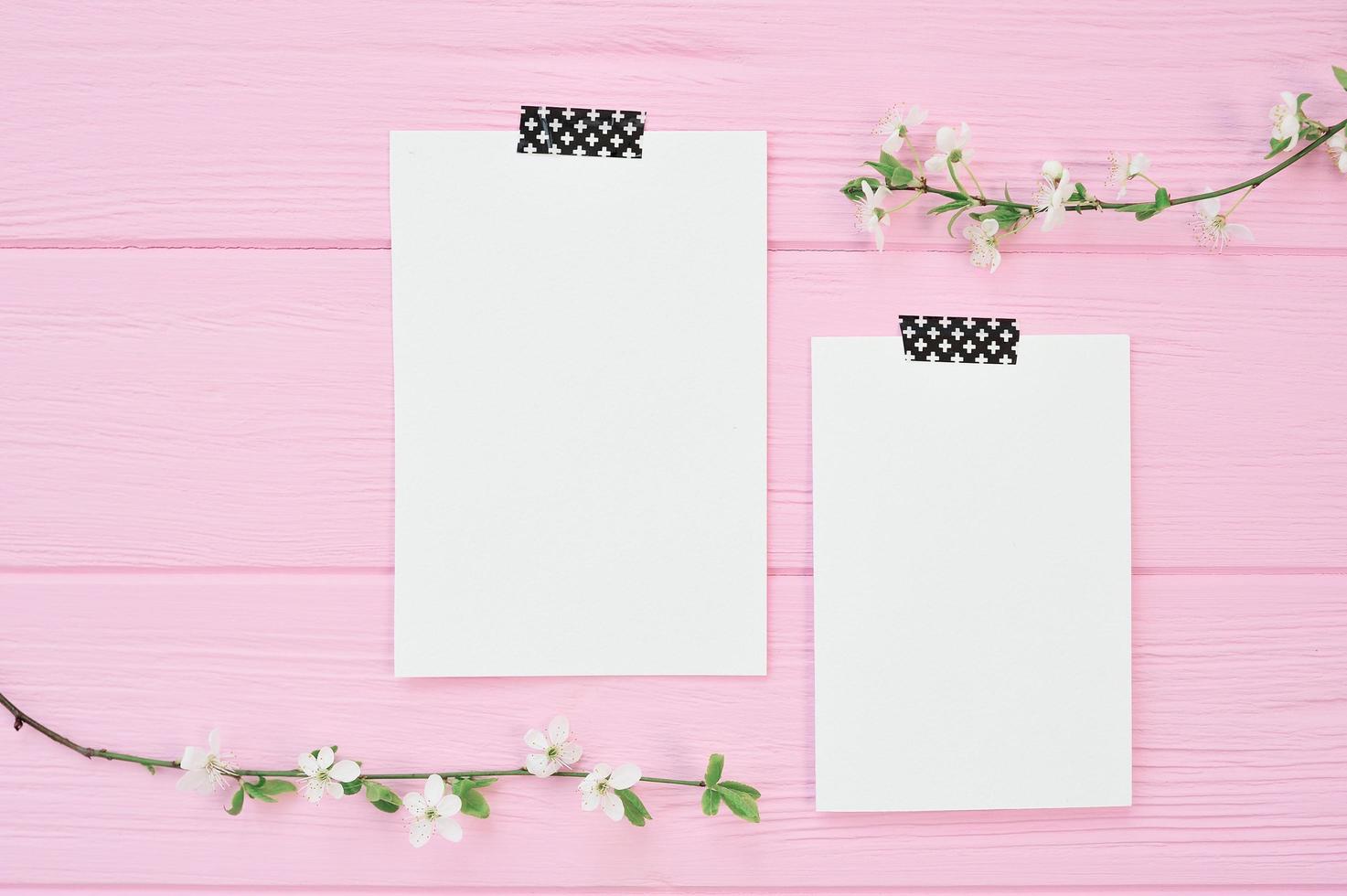 Two sheets of mockup papers on pink background photo