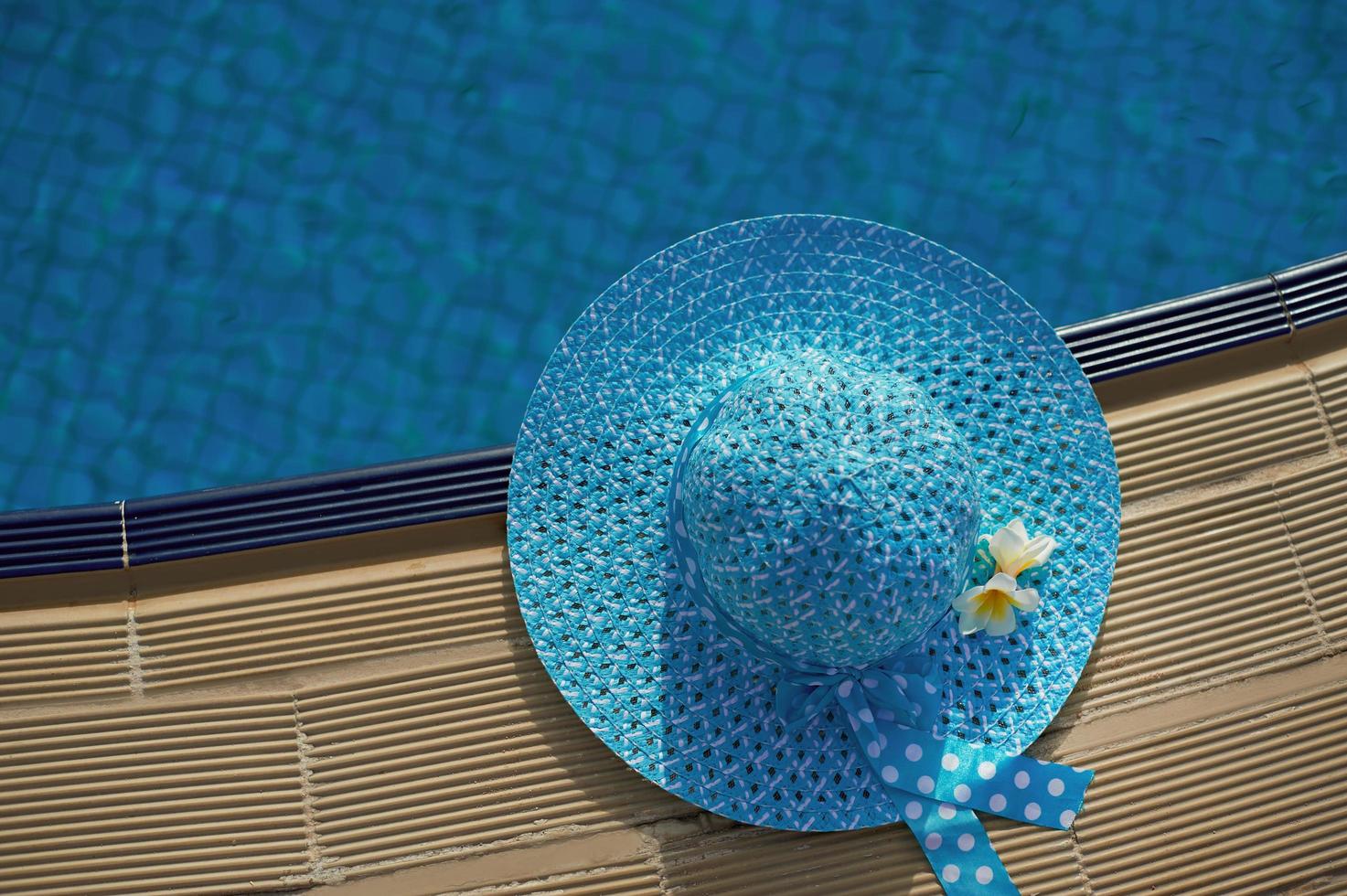 Beach hat next to the pool photo