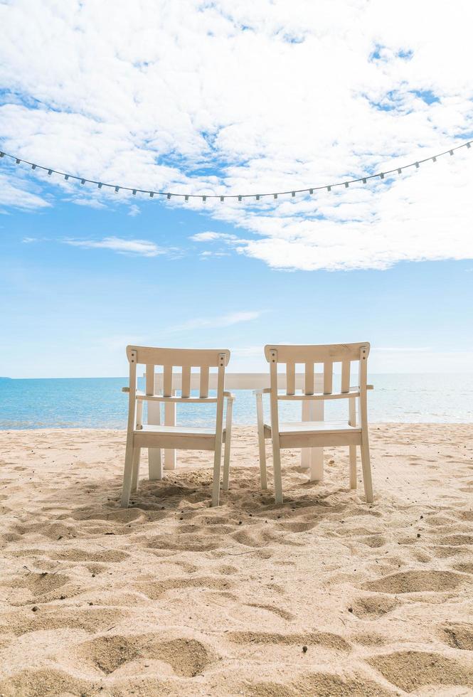 White chairs and table on beach photo