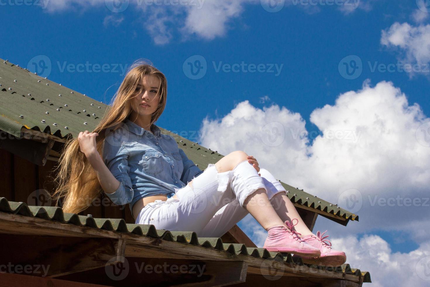 Happy long hair cowgirl on roof photo
