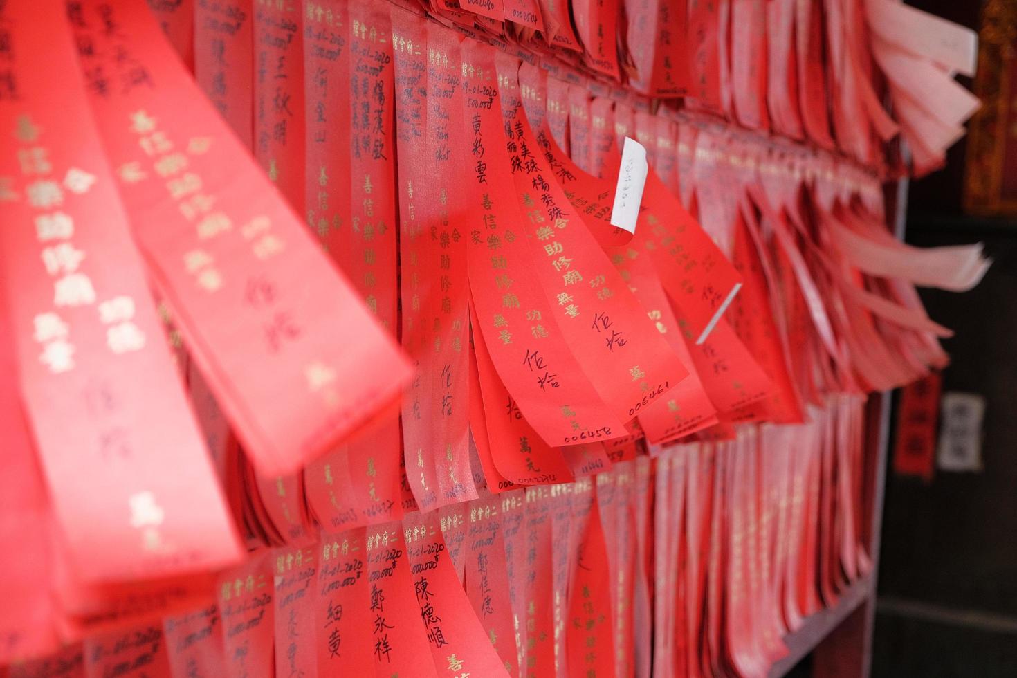 Red paper strips hanging on wall photo