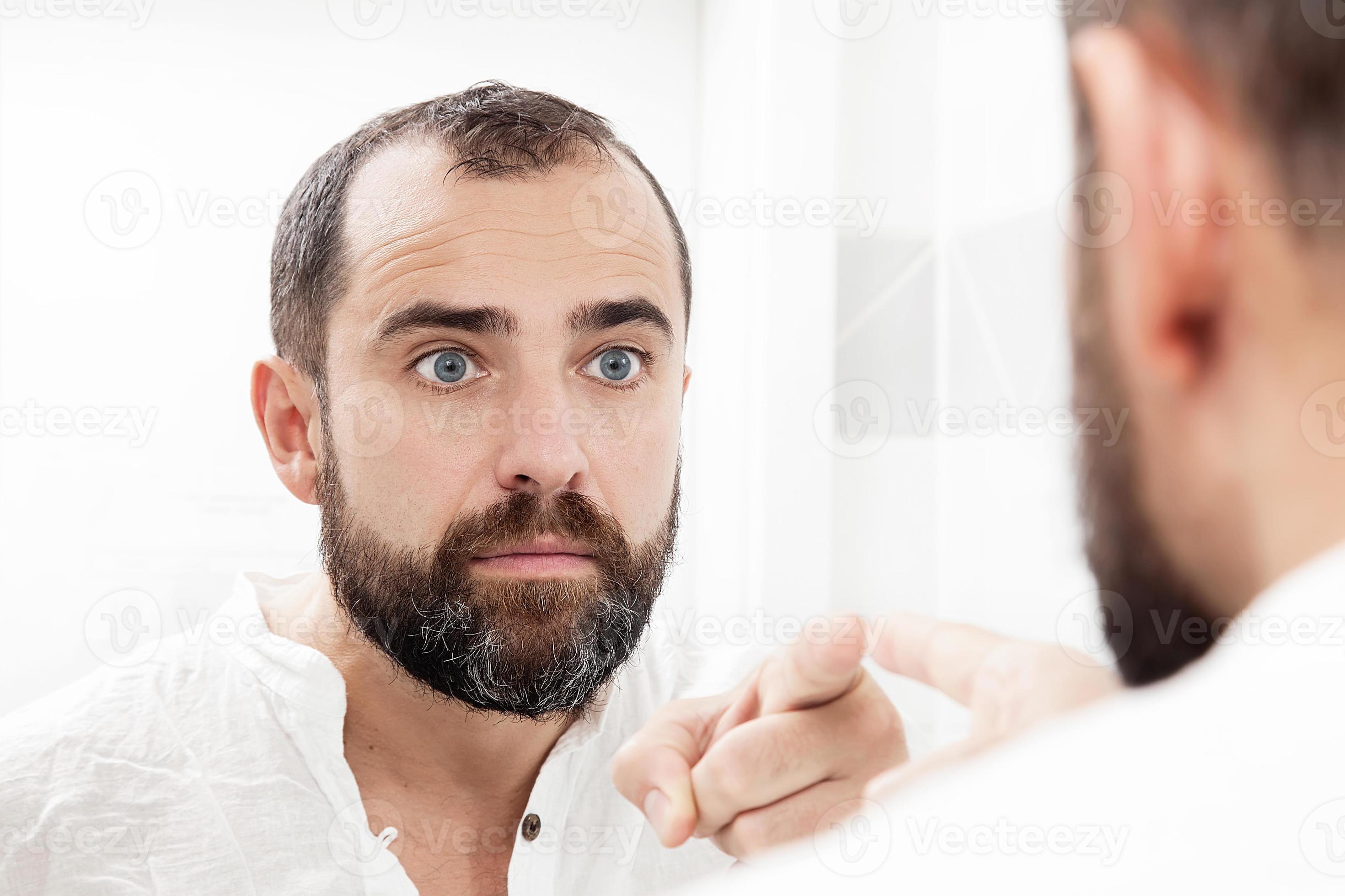 Man looking at himself in the mirror and pointing 1258259 Stock Photo