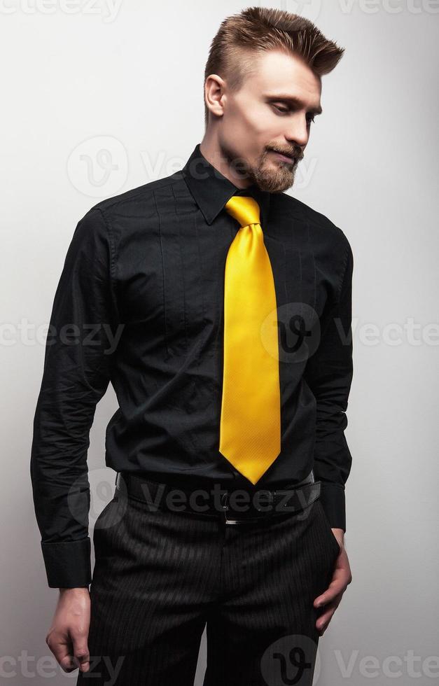 elegante joven apuesto con camisa negra corbata amarilla. Foto de stock en Vecteezy