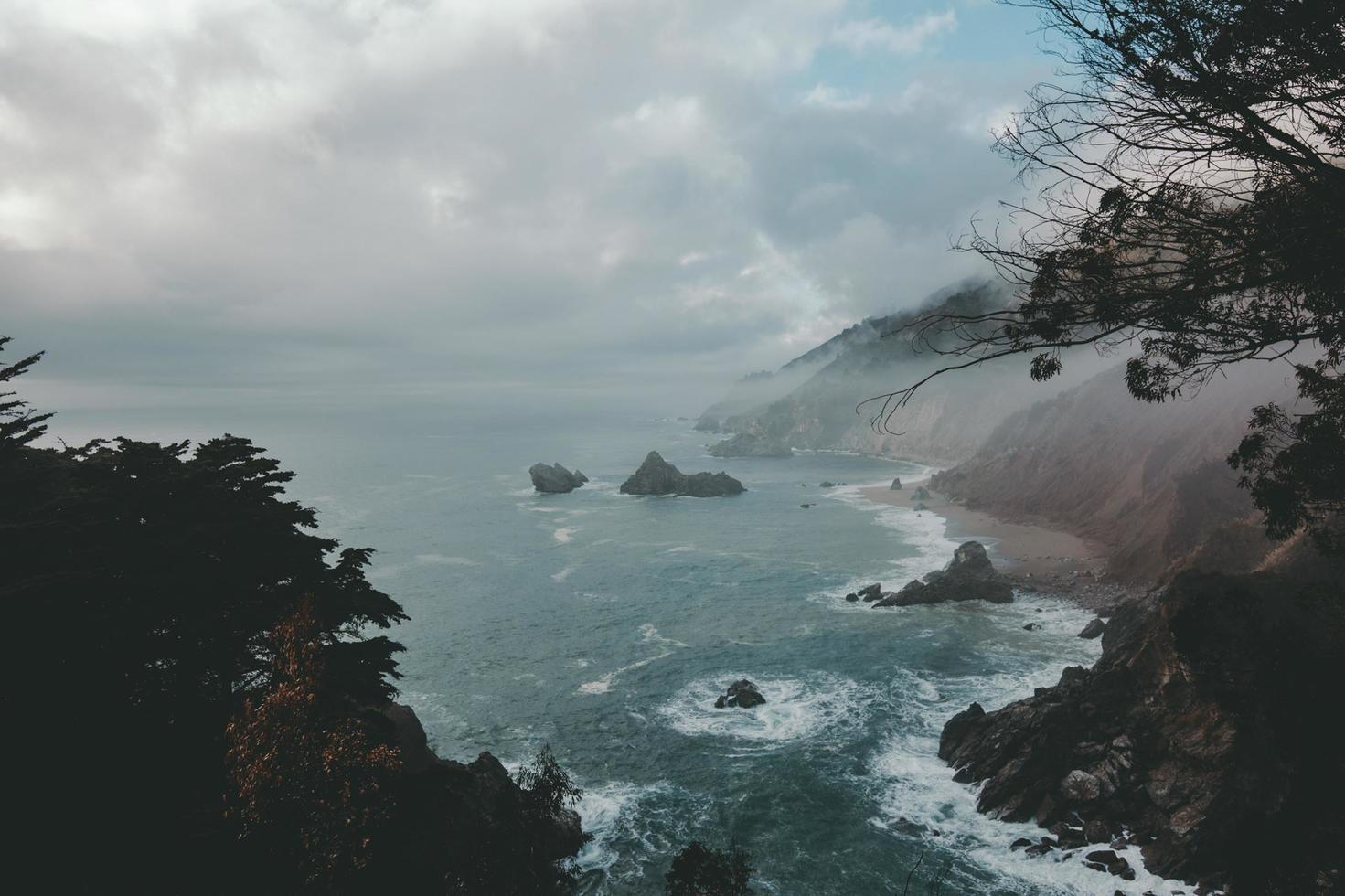 Aerial photography of ocean beside mountain photo