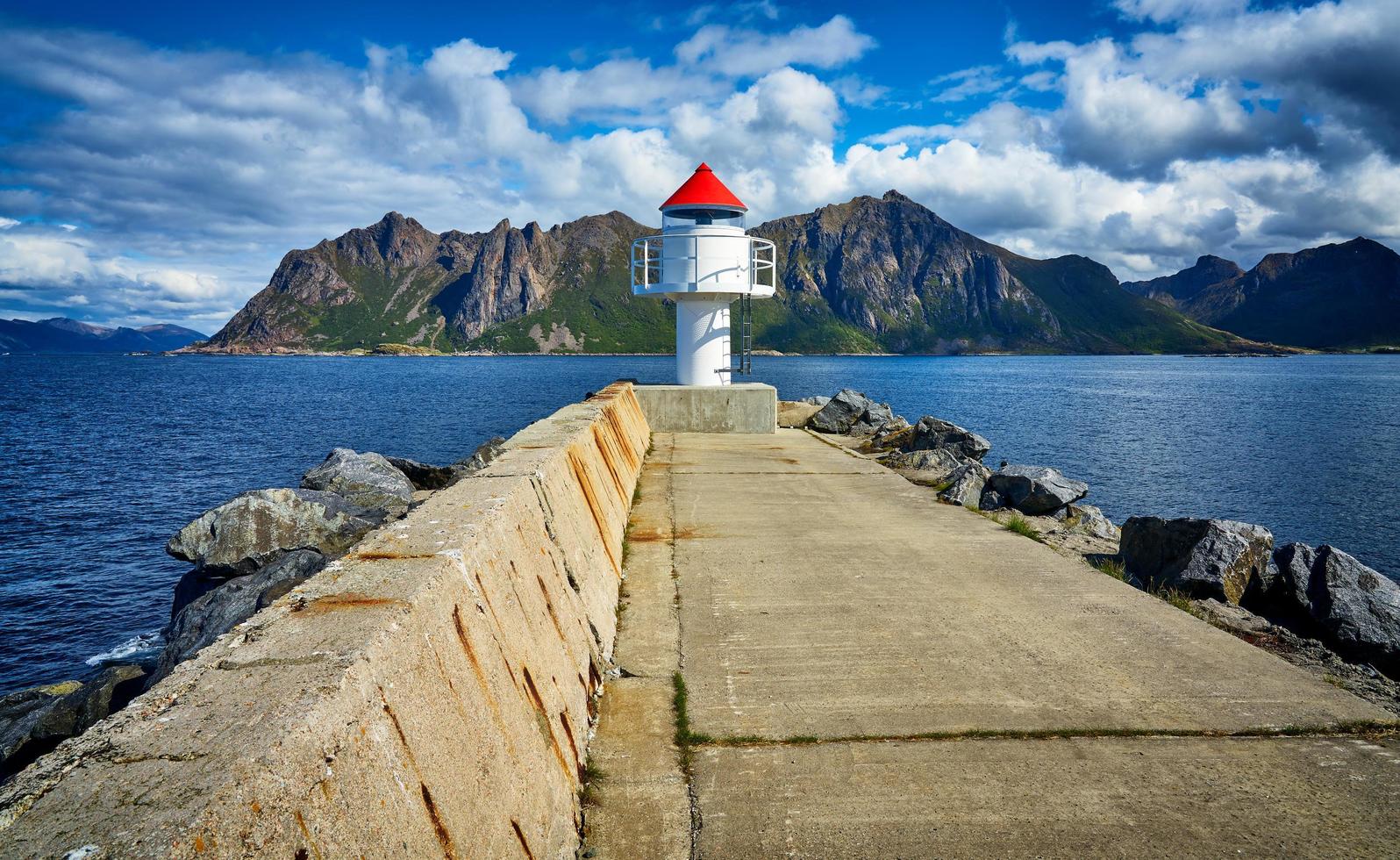 White light house near mountain photo