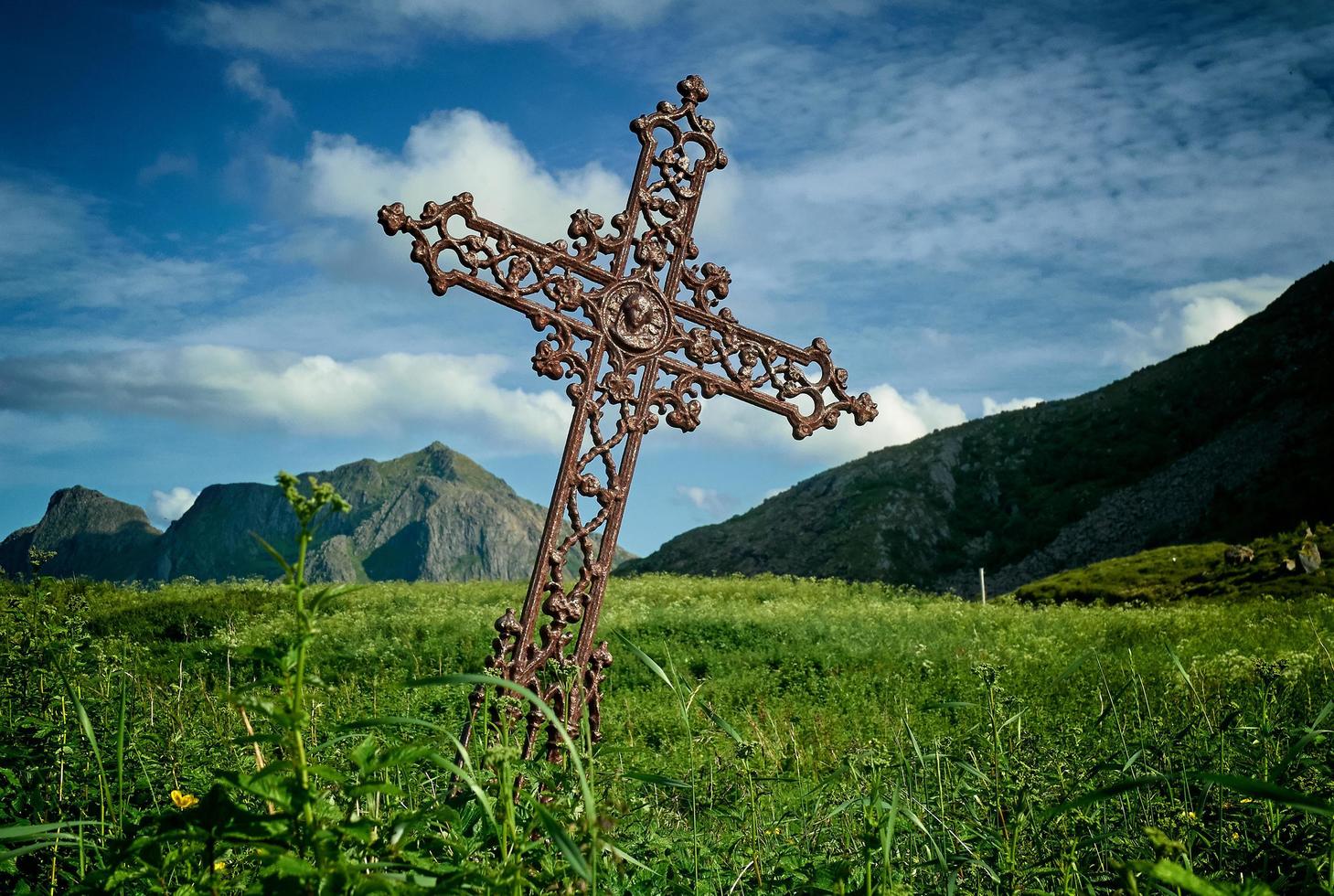 Leaning brown metal cross  photo