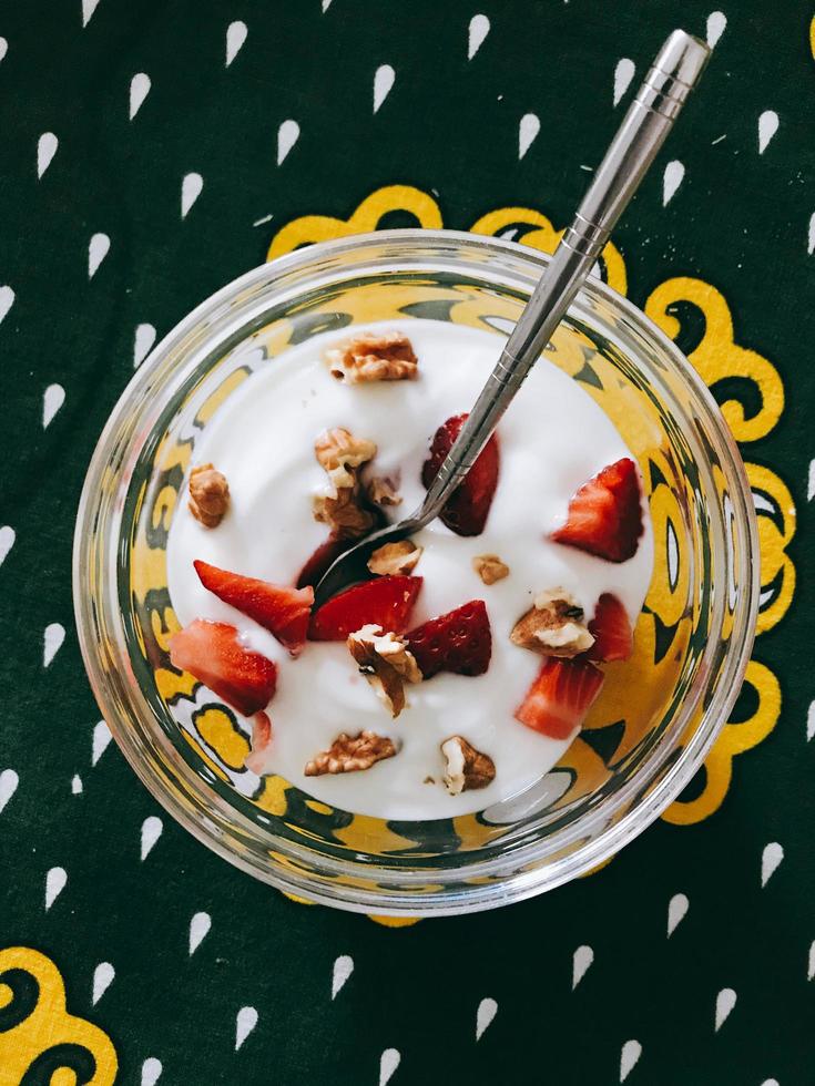 Yogurt with fruit and nut toppings photo
