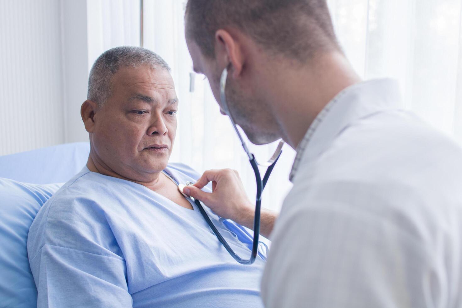 Doctor using stethoscope to listen to patient's heart 1259892 Stock