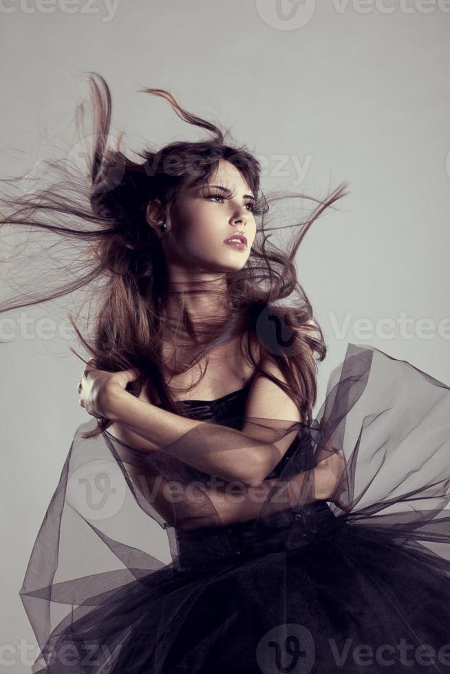 Luxury fashion woman with flying hair. Fashionable girl photo