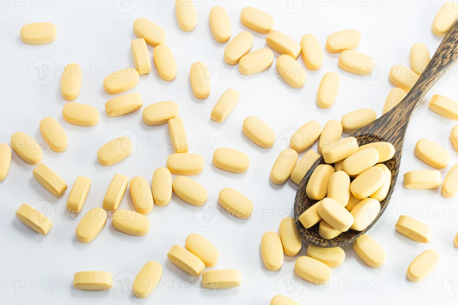 medicine tablets on a wooden spoon photo